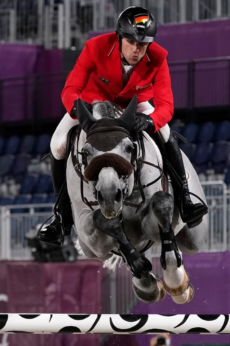 Germany's Christian Kukuk, riding Mumbai, competes during the equestrian jumping individual qualifying.