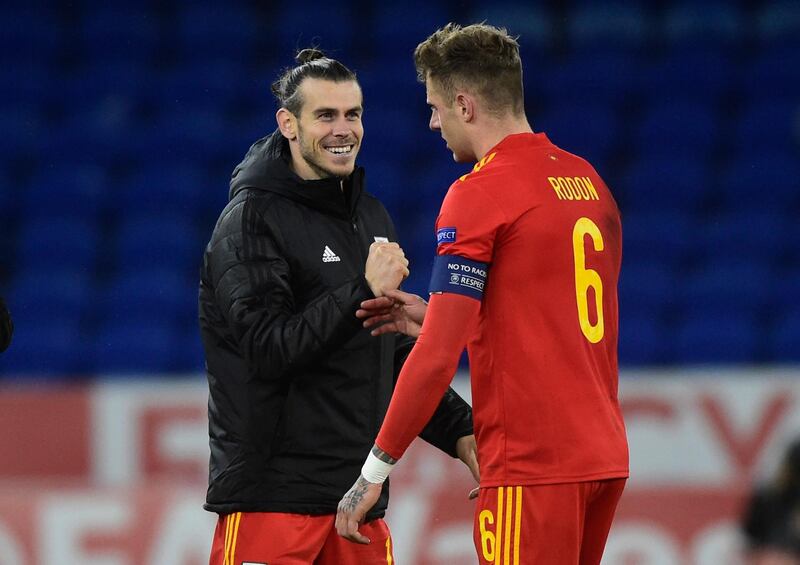 Bale celebrates after the match with Joe Rodon. Reuters