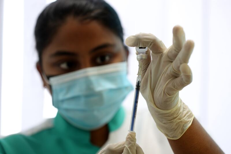 Nurse Deboral Musthafa prepares before administering the Pfizer Covid-19 vaccine at the NMC Royal Hospital DIP in Dubai.