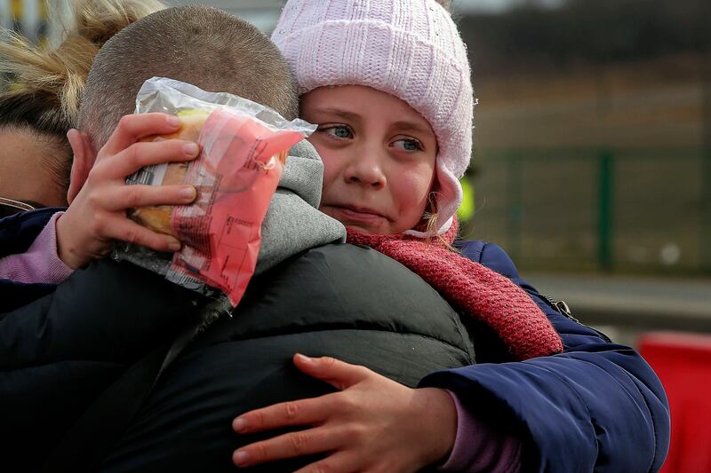 A girl who fled Ukraine is reunited with her father in Medyka, south-eastern Poland. AP Photo