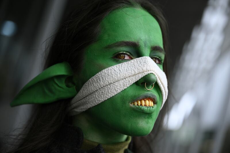 A cosplayer flashes her dental efforts at the show.