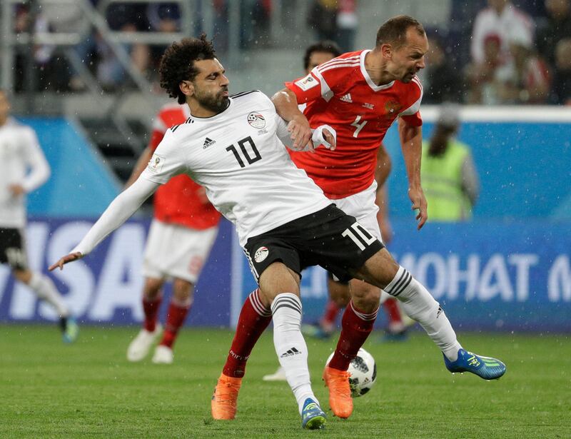 Russia's Sergei Ignashevich, right, challenges for the ball Egypt's Mohamed Salah, left, during the group A match between Russia and Egypt at the 2018 soccer World Cup in the St. Petersburg stadium in St. Petersburg. Gregorio Borgia / AP Photo