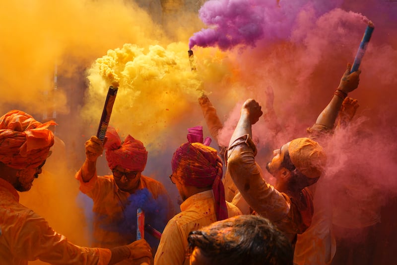 Revellers dance and throw coloured powder to celebrate the Hindu festival of Holi, in Hyderabad, India. AP