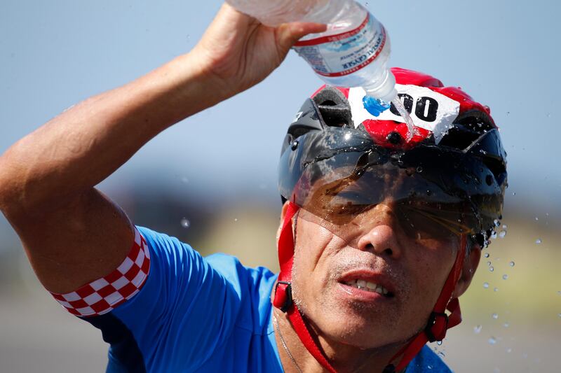 Takeshi Araki, of Japan, splashes water on his face while racing his bicycle at the Ironman World Championship Triathlon in Kailua-Kona, Hawaii. Marco Garcia / AP Photo