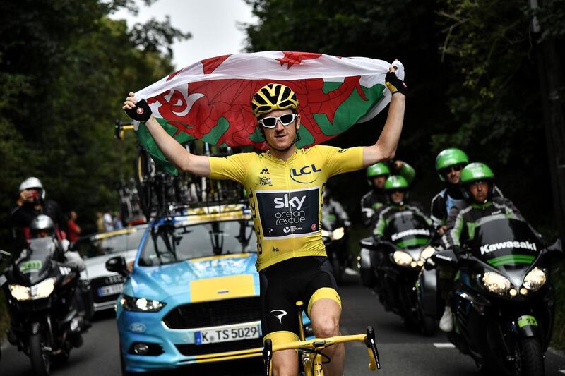 Thomas holds the Welsh flag. Reuters
