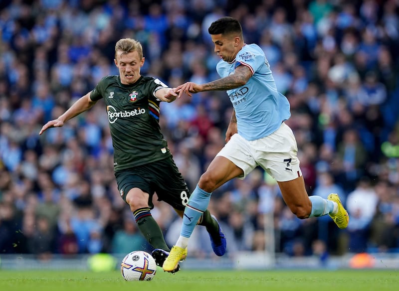 Southampton's James Ward-Prowse and Manchester City's Joao Cancelo battle for the ball in a Premier League match. PA