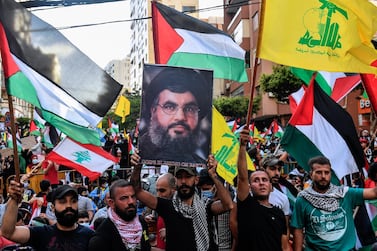 Lebanese protesters wave Palestinian and Hezbollah flags and shout anti-Israel slogans in Beirut on Monday. EPA