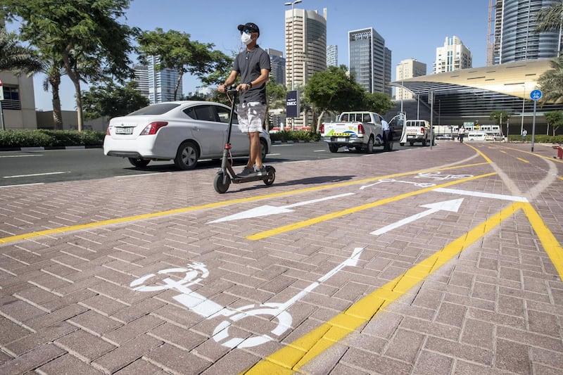 DUBAI, UNITED ARAB EMIRATES. 26 OCTOBER 2020. E-scooter trials rolled out in five areas across city for a year long project for commuters to rent and use e-scooters while commuting to and from tram and metro stations. Special cycle and scooter lanes in JLT next to Al Mas tower. (Photo: Antonie Robertson/The National) Journalist: Kelly Clarke. Section: National.
