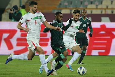 UAE's midfielder Tahnoon al-Zaabi (C) vies for the ball with Iran's midfielder Saeid Ezatolahi (L) during the 2022 Qatar World Cup Asian Qualifiers football match between Iran and United Arab Emirates, at the Azadi Sports Complex in the Iranian capital Tehran, on February 1, 2022.  (Photo by Atta KENARE  /  AFP)