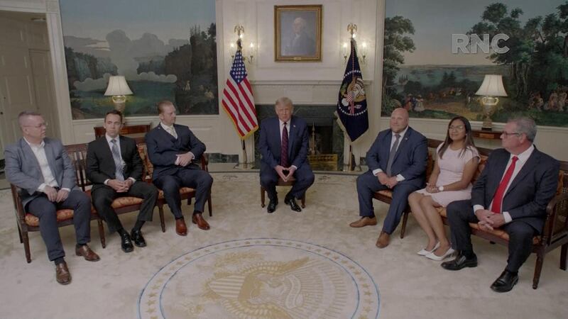 US. President Donald Trump, flanked by people who were held hostage abroad, speaks by video feed during the largely virtual 2020 Republican National Convention broadcast from Washington. Reuters