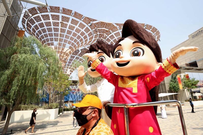 The mascots Rashid and Latifa go on parade. Photo: AFP