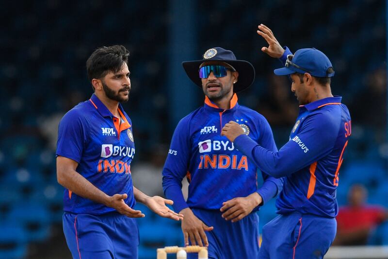 Shardul Thakur (L) and Shikhar Dhawan (C) of India celebrate the dismissal of Sharmarh Brooks of West Indies during the 1st ODI match between West Indies and India at Queens Park Oval, Port of Spain, Trinidad and Tobago, on July 22, 2022.  (Photo by Randy Brooks  /  AFP)