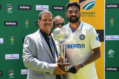 India's Mohammed Siraj, right, is awarded the player of the match trophy after the second Test against South Africa at Newlands on January 4, 2024. AFP