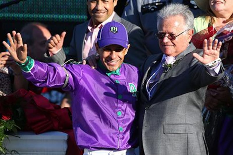 Jockey Victor Espinoza, left, and trainer Art Sherman celebrate in the winners circle after guiding California Chrome to win the 140th running of the Kentucky Derby at Churchill Downs. Andy Lyons / Getty Images / AFP