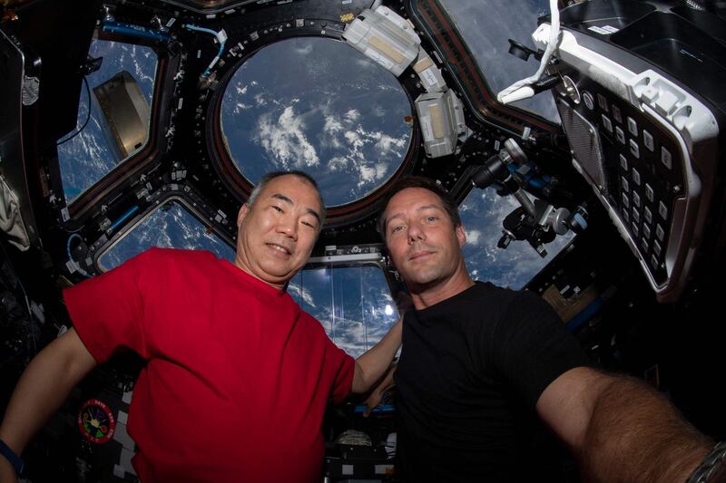 Astronauts Soichi Wakata, left, of the Japan Aerospace Exploration Agency, and Thomas Pesquet, of the European Space Agency, pose for a portrait inside the cupola, the International Space Station's 'window to the world'. AFP