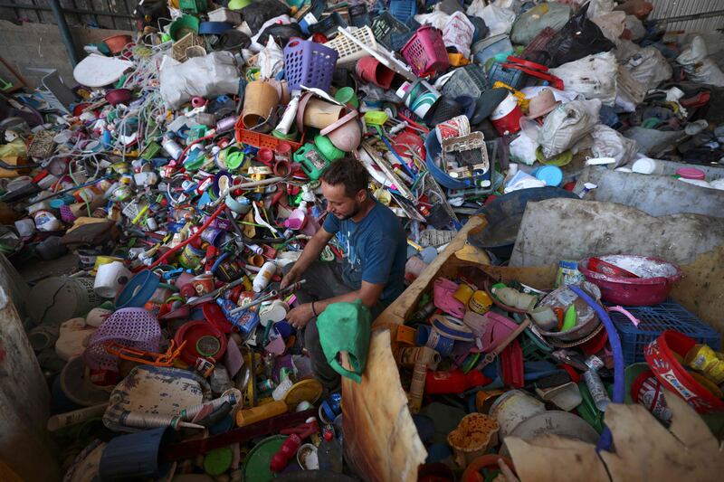 A Palestinian worker in Jabalia on the northern Gaza Strip prepares plastic for processing to extract fuel. All photos AFP