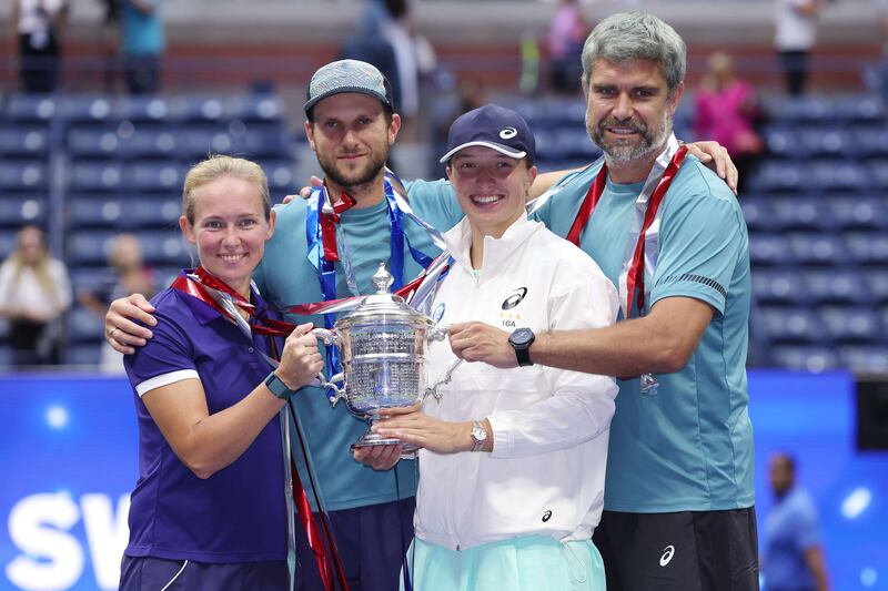 Iga Swiatek and her team celebrate with the trophy after her win against Ons Jabeur in the US Open final. Getty