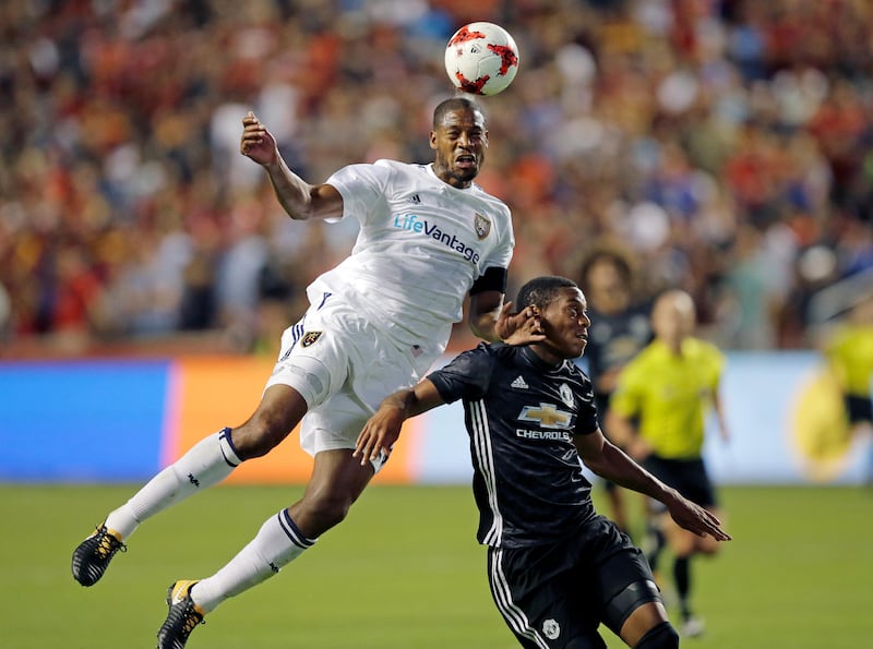 Real Salt Lake defender Chris Schuler, left, heads the ball ahead of Manchester United forward Anthony Martial. Rick Bowmer / AP Photo