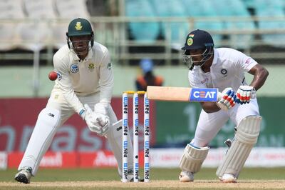Indian cricketer Mayank Agarwal (R) plays a shot as South African wicketkeeper Quinton de Kock (L) looks on during the second day's play of the first Test match between India and South Africa at the Dr. Y.S. Rajasekhara Reddy ACA-VDCA Cricket Stadium in Visakhapatnam on October 3, 2019. ----IMAGE RESTRICTED TO EDITORIAL USE - STRICTLY NO COMMERCIAL USE----- / GETTYOUT
 / AFP / NOAH SEELAM / ----IMAGE RESTRICTED TO EDITORIAL USE - STRICTLY NO COMMERCIAL USE----- / GETTYOUT
