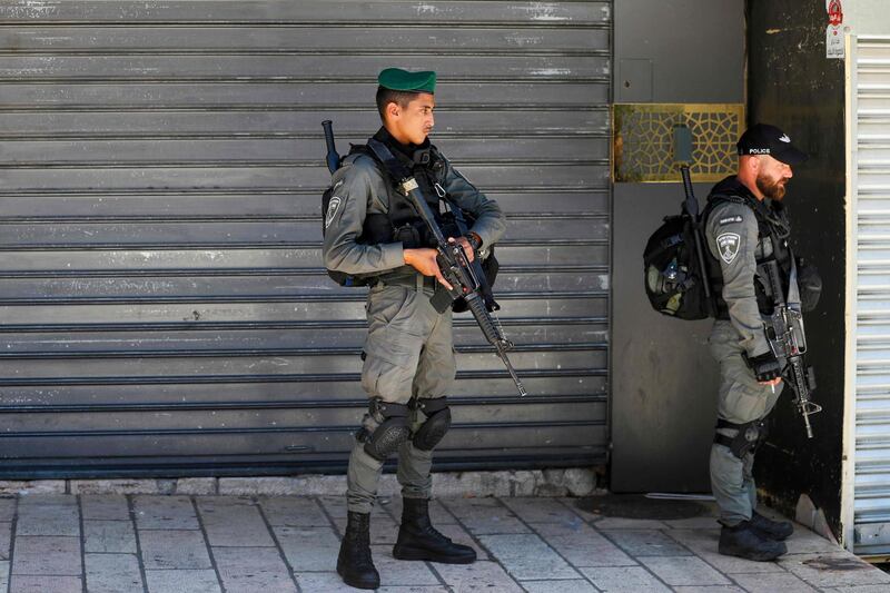 Israeli border police stand guard in front of shuttered stores in Arab east Jerusalem. AFP