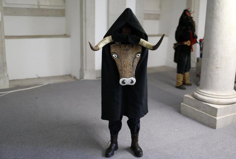 A masked man awaits the start of the parade of the 9th International Festival of the Iberian Mask in Lisbon. The festival runs until next Sunday and about 450 masked people from Spain, Portugal and Italy are participating. Rafael Marchante / Reuters