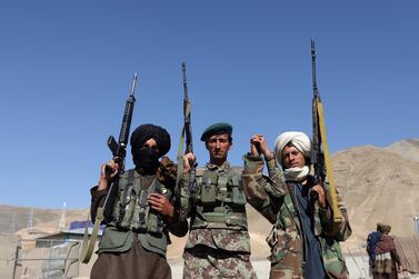 Taliban fighters pose with an Afghan soldier during a three-day ceasefire for Eid Al Fitr in 2018. EPA