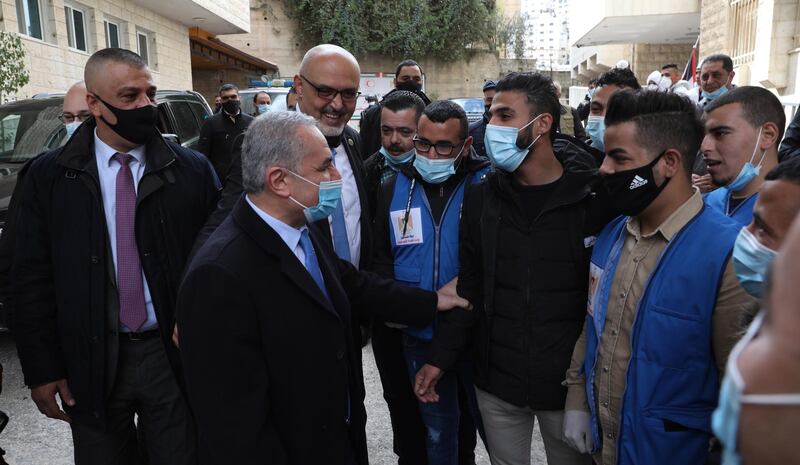 Palestinian Prime Minister Mohammad Shtayyeh talks to medical staff after the opening of Al-Hilal Hospital in the west bank city of Nablus. EPA