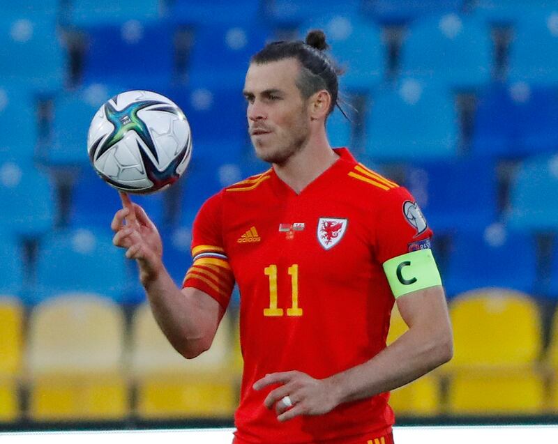 Gareth Bale holds the match ball after scoring their third goal to complete his hat-trick. Reuters