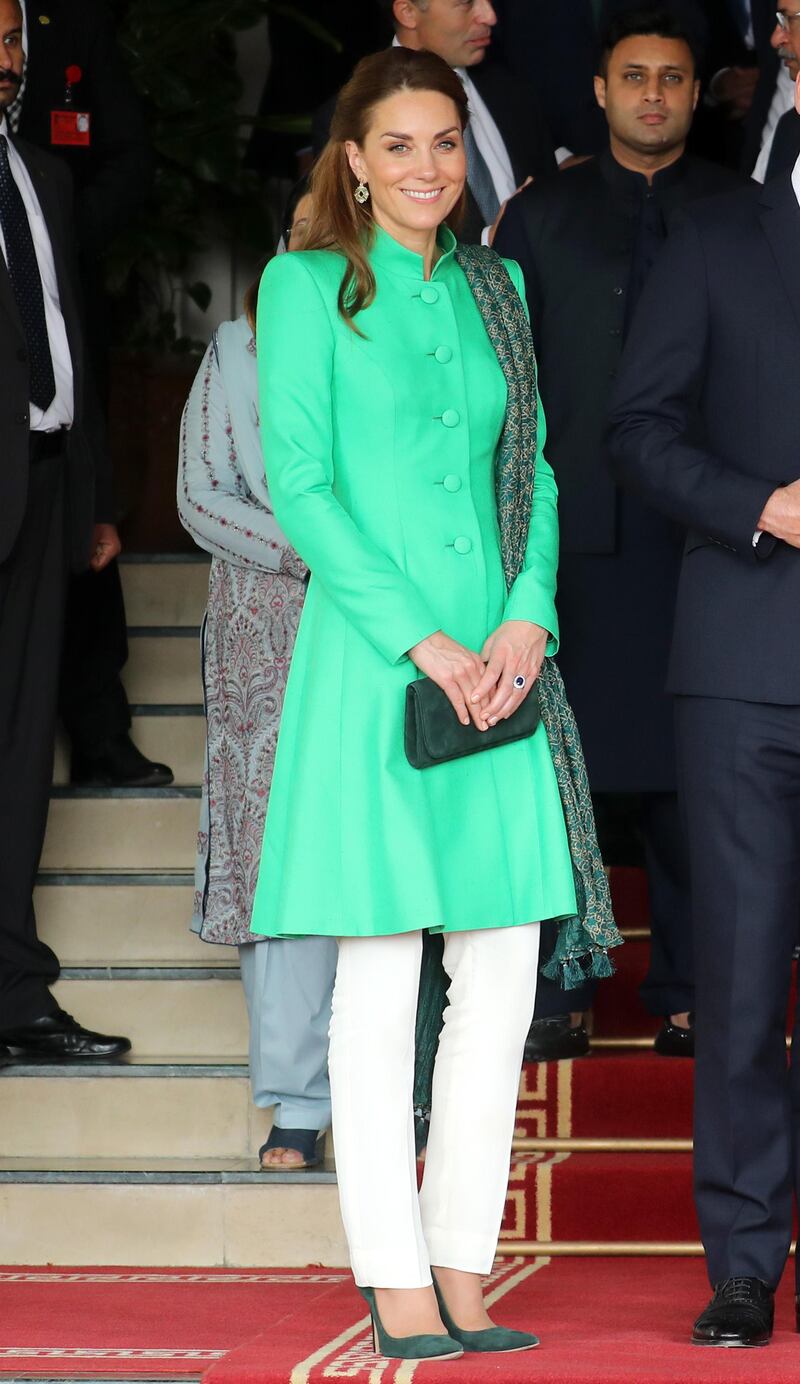 Catherine, Duchess of Cambridge, wears a green tunic coat by Catherine Walker and white trousers by Maheen Khan to meet Pakistan's Prime Minister Imran Khan at his official residence on Tuesday, October 15, 2019 in Islamabad, Pakistan. Getty Images