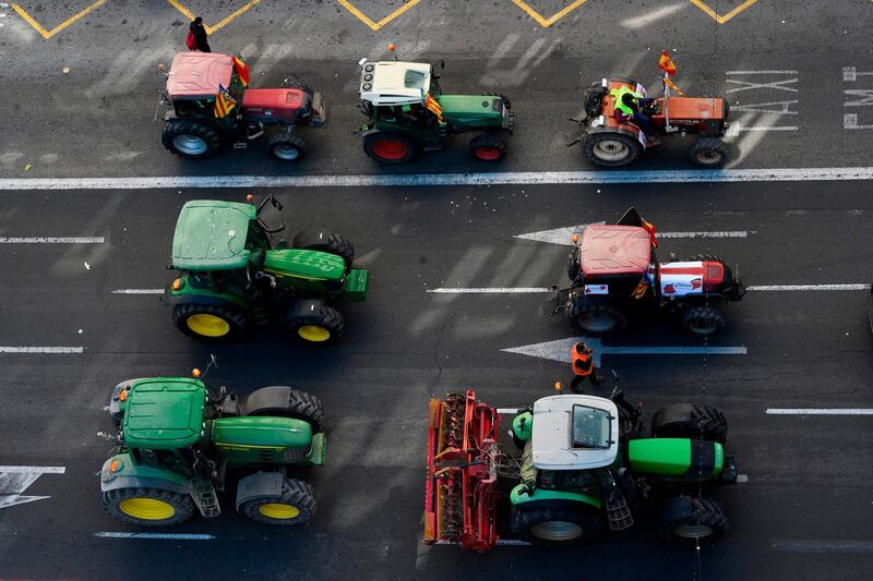 Farmers attend a demonstration with their tractors to demand fairer prices for their produce.  AFP