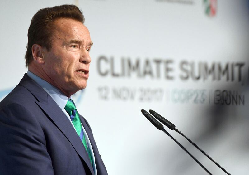 Former governor of California Arnold Schwarzenegger talks in the "Bonn-Zone" during the World Climate Conference in Bonn, Germany, Sunday Nov. 12, 2017.  During the summit, cities and regions emphasize that climate protection is not only an issue for national governments. (Henning Kaiser/dpa via AP)