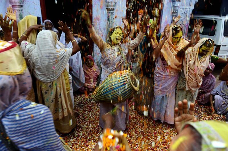 Indian widows throw coloured powder and flower petals as they take part in Holi celebrations at an ashram in Vrindavan. Chandan Khanna / AFP Phot