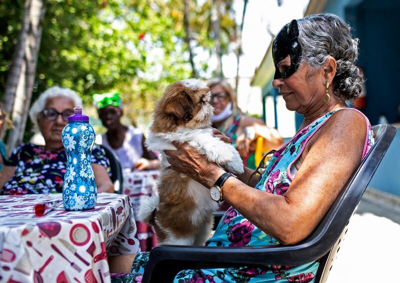 An elderly woman holds a dog named Cristal at a nursing home in Sepetiba, Brazil, on October 1. The nursing home brought the animals, who they rescued from abandonment, to provide a little relief from the isolation many elderly people feel, cut off from friends and family due to fear of contagion from the new coronavirus. Bruna Prado / AP