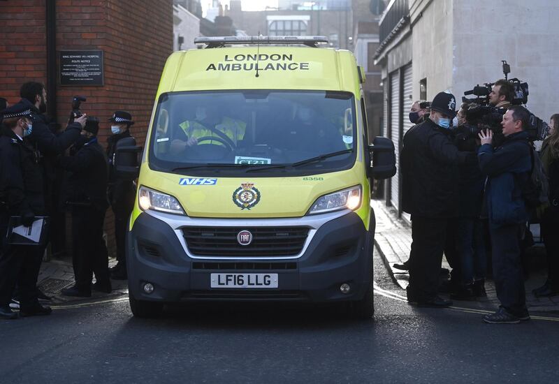 An ambulance receives a patient before leaving King Edward VII's Hospital. EPA