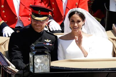 FILE - In this Saturday, May 19, 2018 file photo, Britain's Prince Harry and Meghan Markle leave Windsor Castle in a carriage after their wedding at St. George's Chapel in Windsor, near London, England. Nine months after her globally televised wedding extravaganza, the 37-year-old woman now formally known as the Duchess of Sussex is finding that life in the royal fishbowl carries not just glamour and great charitable opportunities but liabilities as well. (AP Photo/Matt Dunham, file)