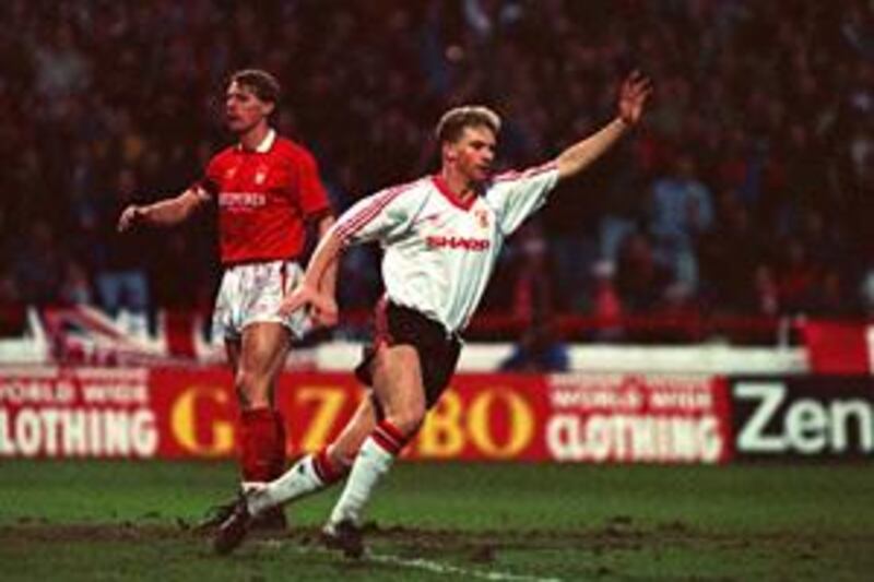 Mark Robins celebrates scoring for Manchester United against Nottingham Forest in a 1990 FA Cup match.