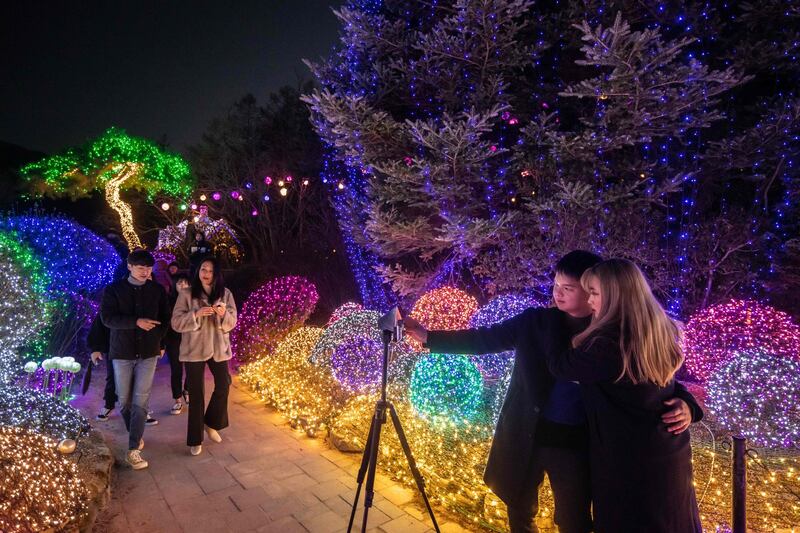 Visitors take a selfie as they look at an annual light display at the 'Garden on Morning Calm', near Gapyeong, east of Seoul.   AFP