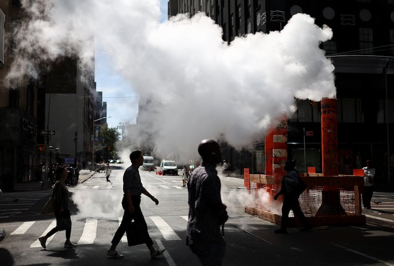 Steam rises as people cross a street in Manhattan on June 16, 2024. Reuters