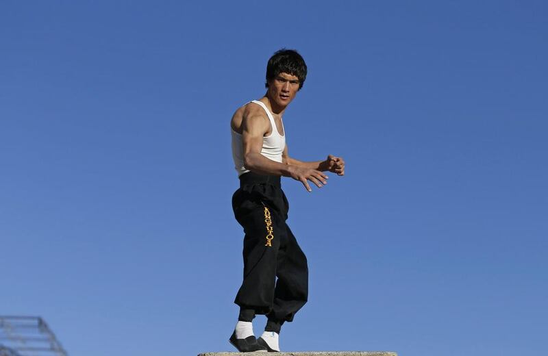 During a workout at the palace, adorned with photos of thousands of civilian war victims as part of a protest exhibition, Alizada showed off his wiry physique, doing push-ups on his fingertips and sparring with a partner. Two assistants dabbed his brow and fixed his hair for the cameras. Mohammad Ismail / Reuters 