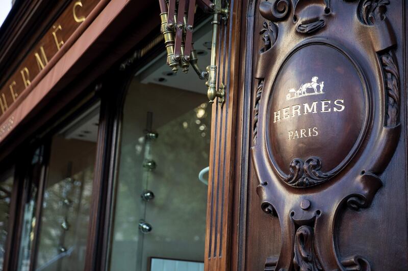 The Hermes International horse and carriage logo sits on the woodwork exterior of the Hermes luxury goods store on George IV avenue, in Paris, France, on Tuesday, July 28, 2020. LVMH Moet Hennessy Louis Vuitton SE follows Richemont and Burberry in reporting what analysts expect will be the industry’s worst quarter ever because of the pandemic. Photographer: Adrienne Surprenant/Bloomberg
