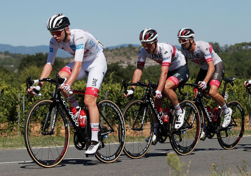 UAE Team Emirates rider Tadej Pogacar, left, wearing the white jersey for best young rider. Reuters