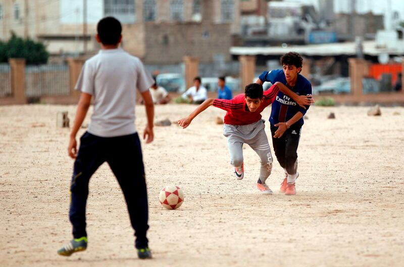 Yemeni youth take part in a football match in their neighbourhood in the capital Sanaa on April 11, 2018.
A shock winning streak has propelled Yemen's youth and men's football teams to the Asian Cup, capturing the beleaguered nation's attention and offering a common goal to a divided country.
The qualification is a first ever for the senior team, currently based in Qatar, and a rare achievement for the under-16s who still train in Yemen. / AFP PHOTO / MOHAMMED HUWAIS