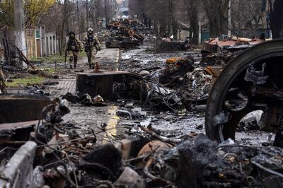 Ukrainian soldiers walk on a street in Bucha after Russian forces withdrew from the city near Kyiv. AP