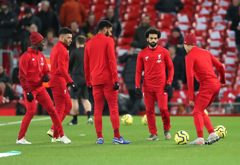 Liverpool's Mohamed Salah (centre) warms up with team-mates. PA