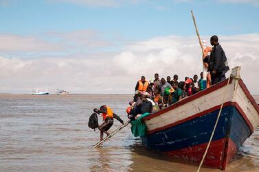 In this photo supplied by the Red Cross Red Crescent Climate Centre survivors of Cyclone Idai arrive by rescue boat in Beira, Mozambique, Thursday, March 21, 2019. The confirmed death toll in Mozambique, Zimbabwe and Malawi surpassed 500, with hundreds more feared dead in towns and villages that were completely submerged. (Photo -Denis Onyodi - Red Cross Red Crescent Climate Centre via AP)
