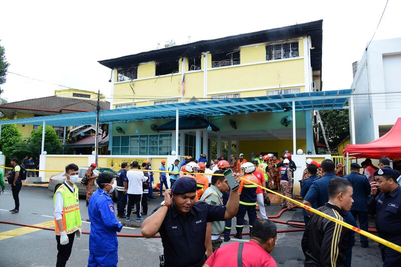 Police and rescue personnel work at an Islamic religious school cordoned off after the fire on the outskirts of Kuala Lumpur. AP Photo