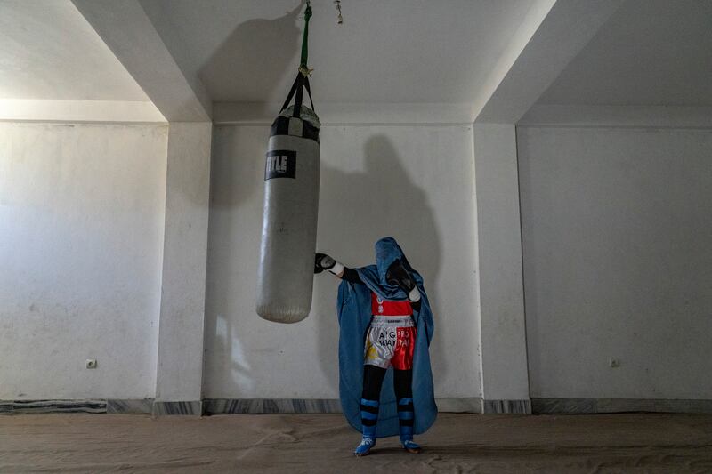 A Muay Thai competitor with a punching bag used for training.