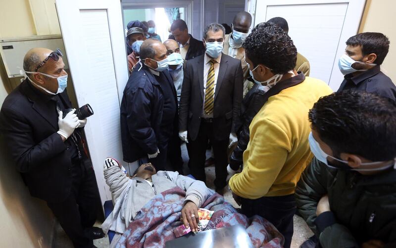 Colonel Mohamed Bashir, director of Libya's Illegal Immigration Control Agency, checks on an African mgirant who was injured after their vehicle was overturned during a truck collision, at a hospital in the town of Beni Walid, 170 kilometres southeast of the capital Tripoli, on February 14, 2018.
At least 19 migrants were killed and more than 100 injured when the truck transporting them crashed in Libya on February 14, a hospital said.
More than 300 migrants, mostly Eritrean and Somali nationals, were on board the vehicle which overturned near the town of Bani Walid. / AFP PHOTO / MAHMUD TURKIA