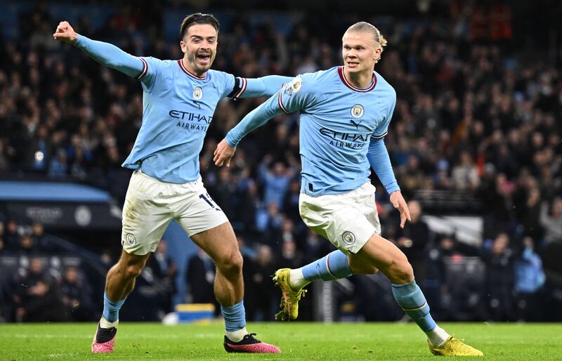 Erling Haaland celebrates with Jack Grealish after scoring. AFP