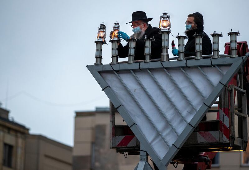 Rabbi Sholom Krinsky lights a menorah during the Jewish holiday of Hanukkah, at the Kudirkos square in Vilnius, Lithuania. AP Photo